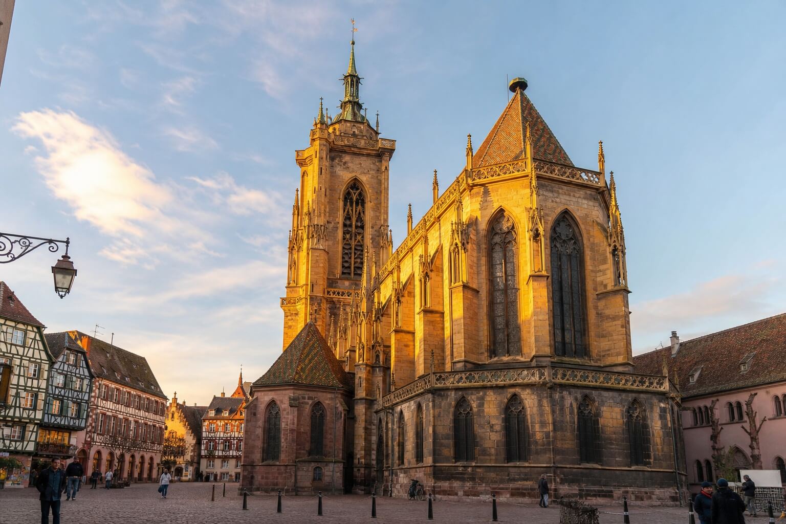 Vue de l’église Saint-Martin de Colmar en grès jaune, entourée de maisons à colombages sur la place centrale