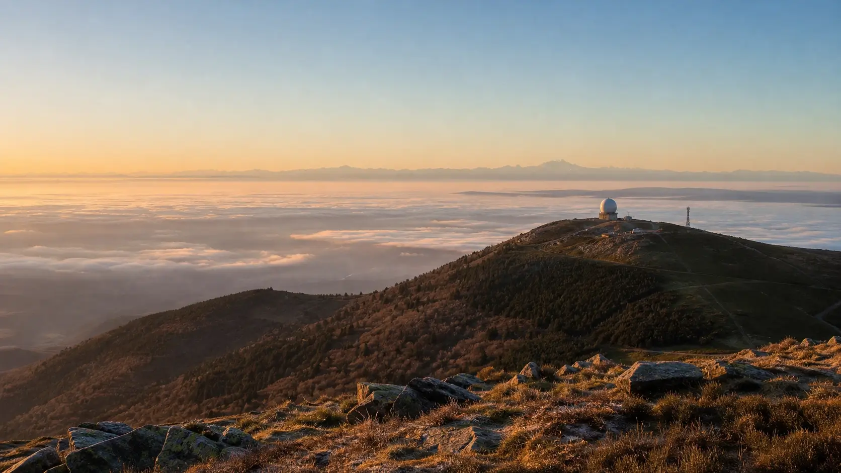 Vue du sommet du Grand Ballon avec le radôme et panorama sur la plaine d’Alsace et les Alpes au loin
